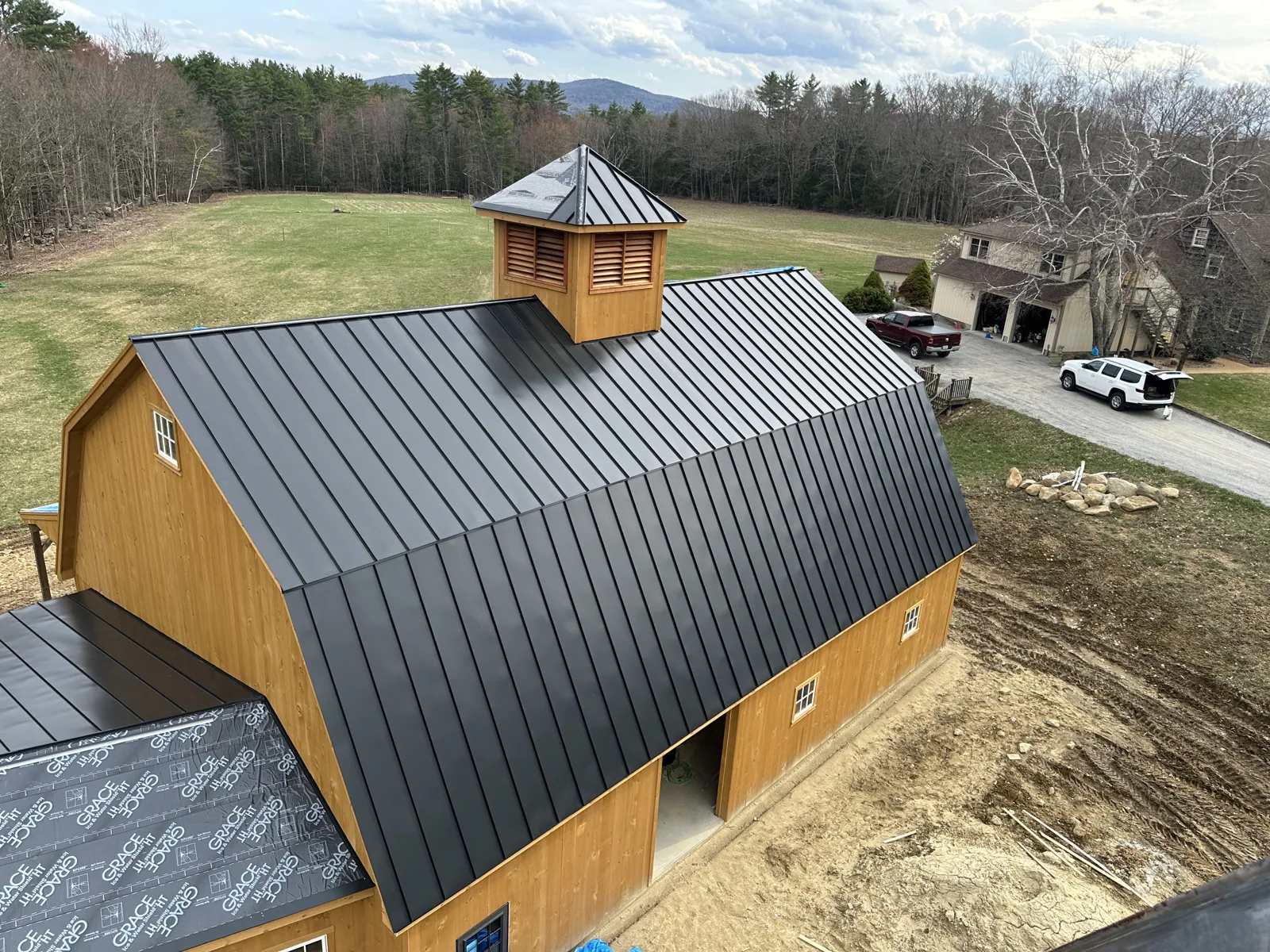 Finished timber-frame barn with a standing-seam metal roof and cupola