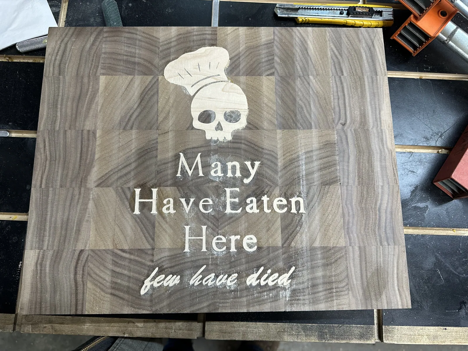 Close view of the chef's-skull and lettering inlay