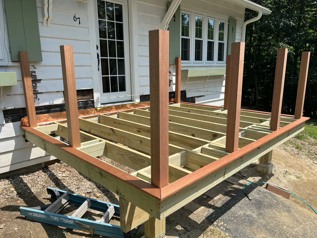 Deck frame with corner posts standing