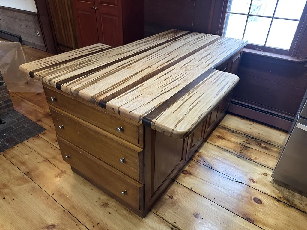 Ambrosia maple kitchen island with a wormy-maple butcher-block top over a wood base with drawers