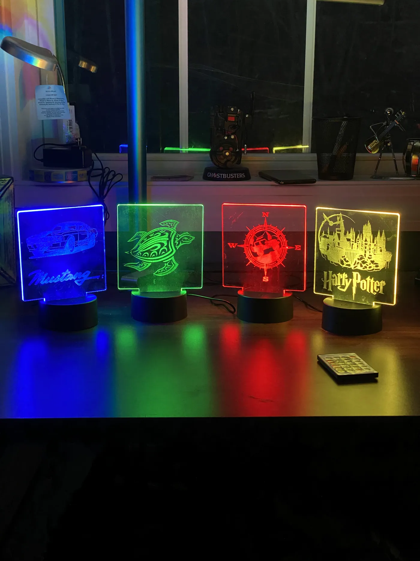 Edge-lit acrylic lamps on color-changing LED bases, engraved with custom designs.