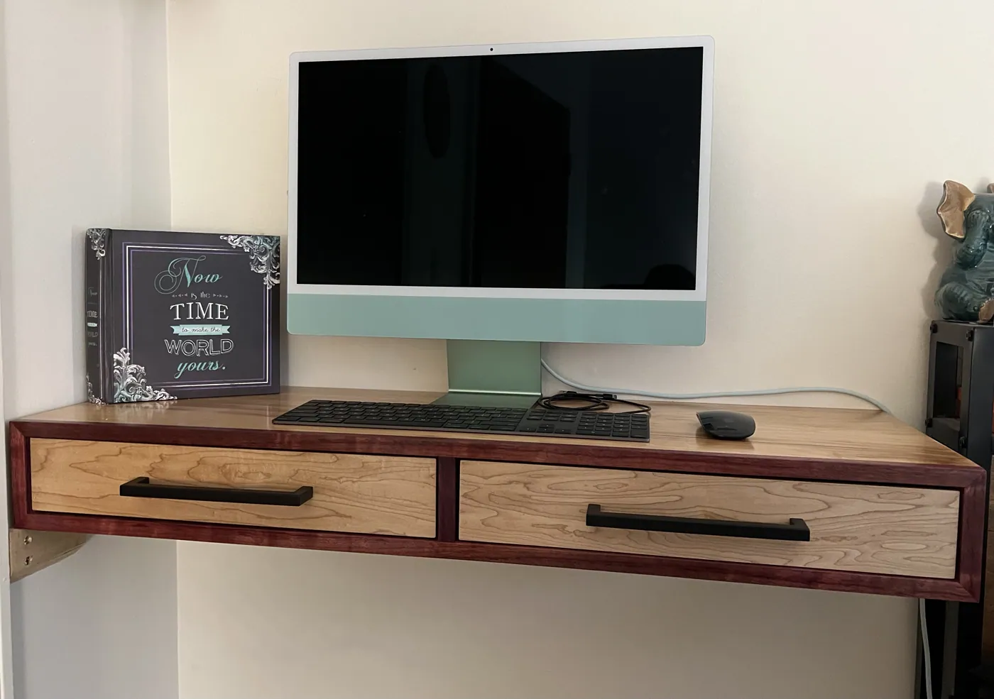 Wall-mounted floating desk in cherry and maple with purpleheart edge banding and two drawers.