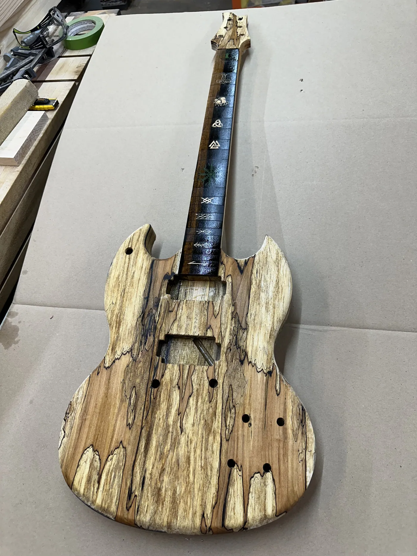 Electric guitar built from spalted maple with a custom-inlaid fretboard.