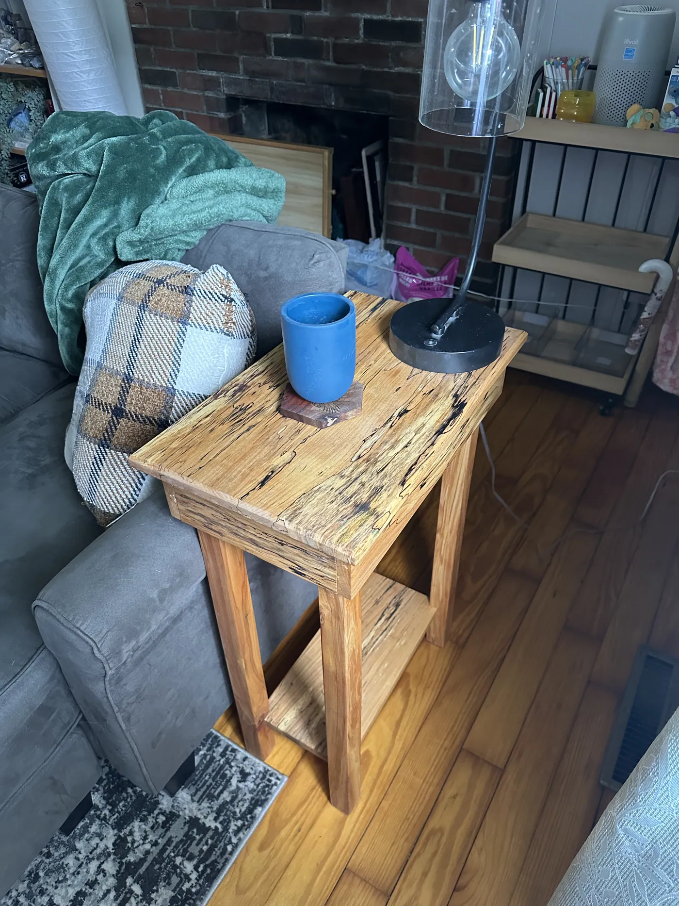 Spalted maple end table with a hidden magnetic drawer, shown finished in its home.