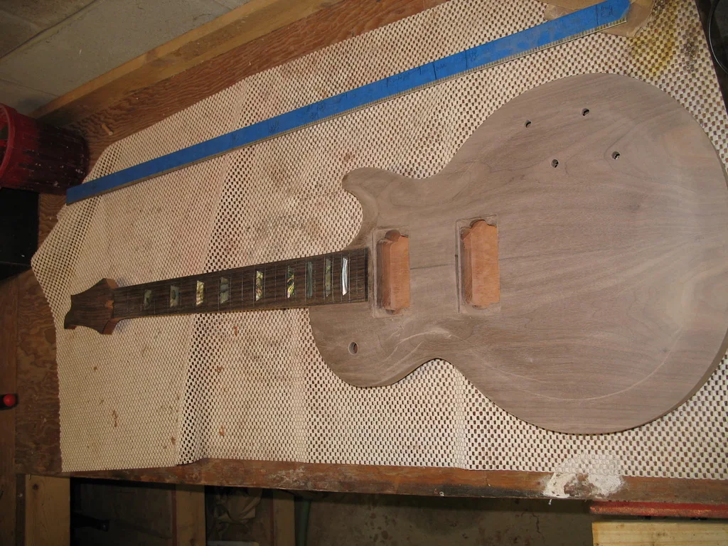 The carved body with the set neck fitted