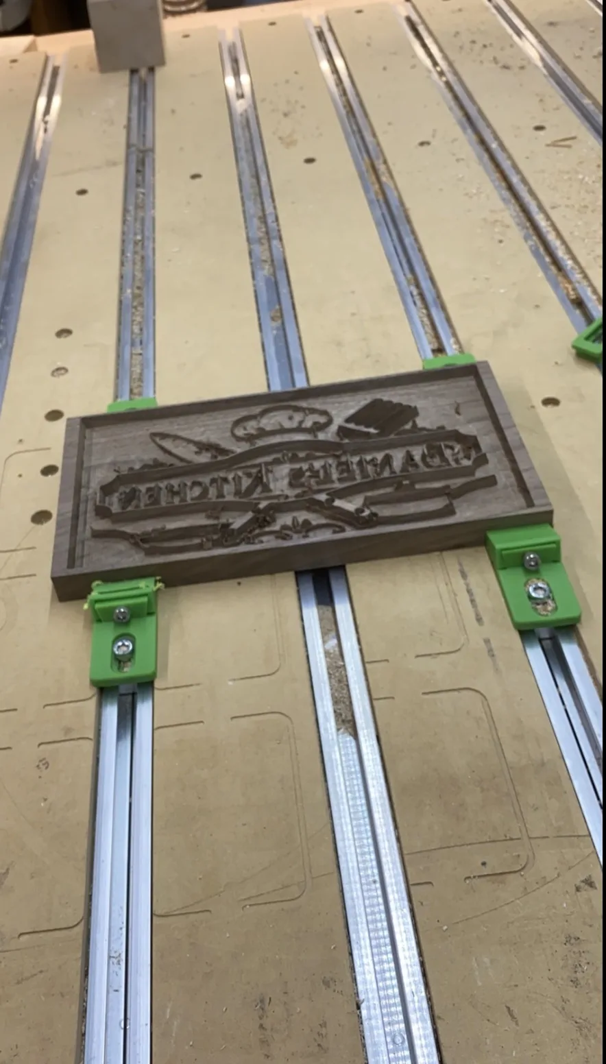 The CNC machine carving the negative of the inlay into the board