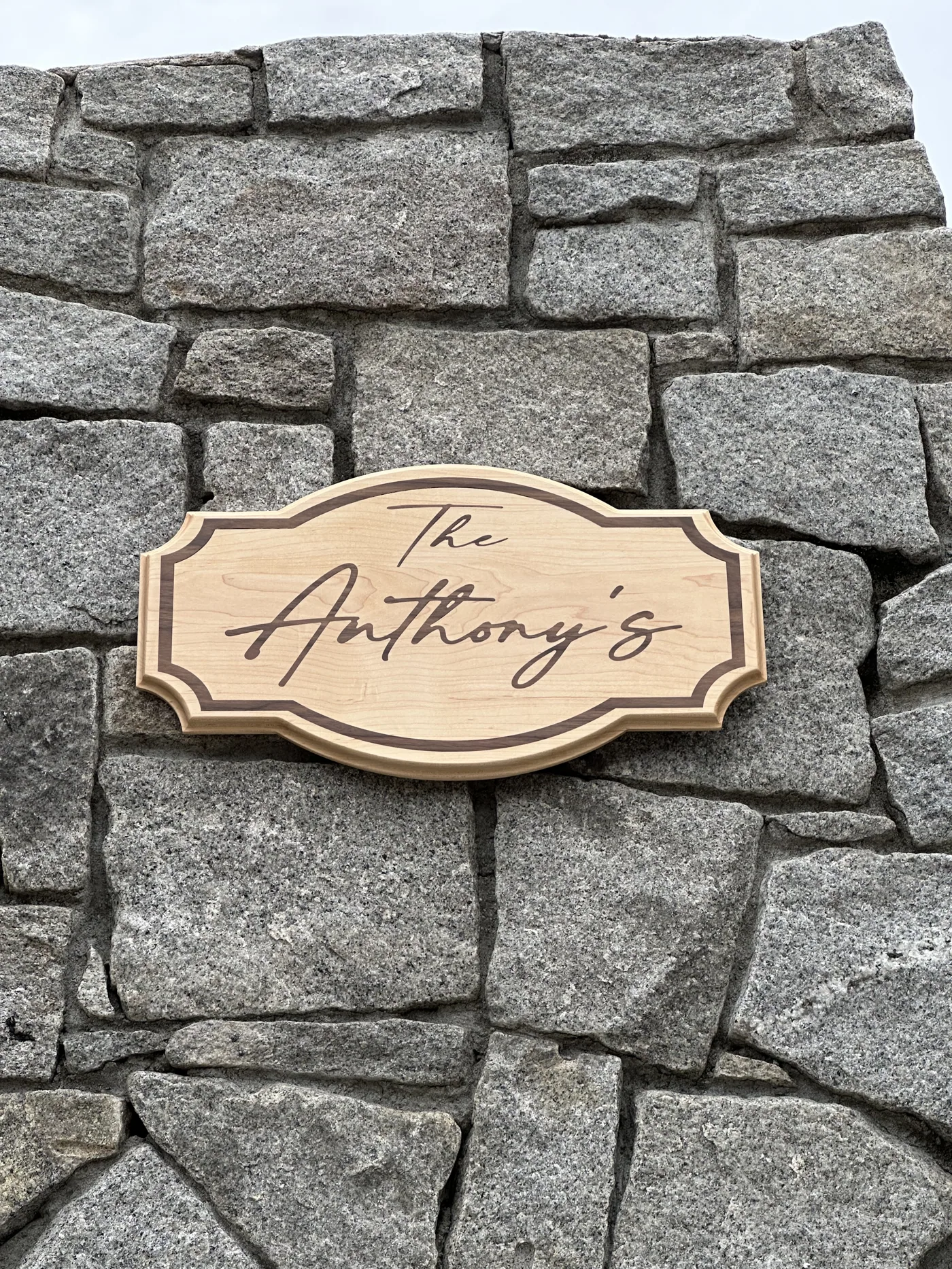 The Anthonys family name sign mounted on a stone wall
