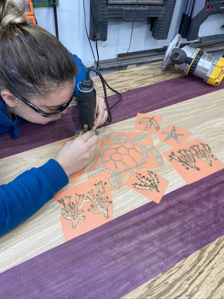 Stencils for the turtle and seaweed being applied to the tabletop