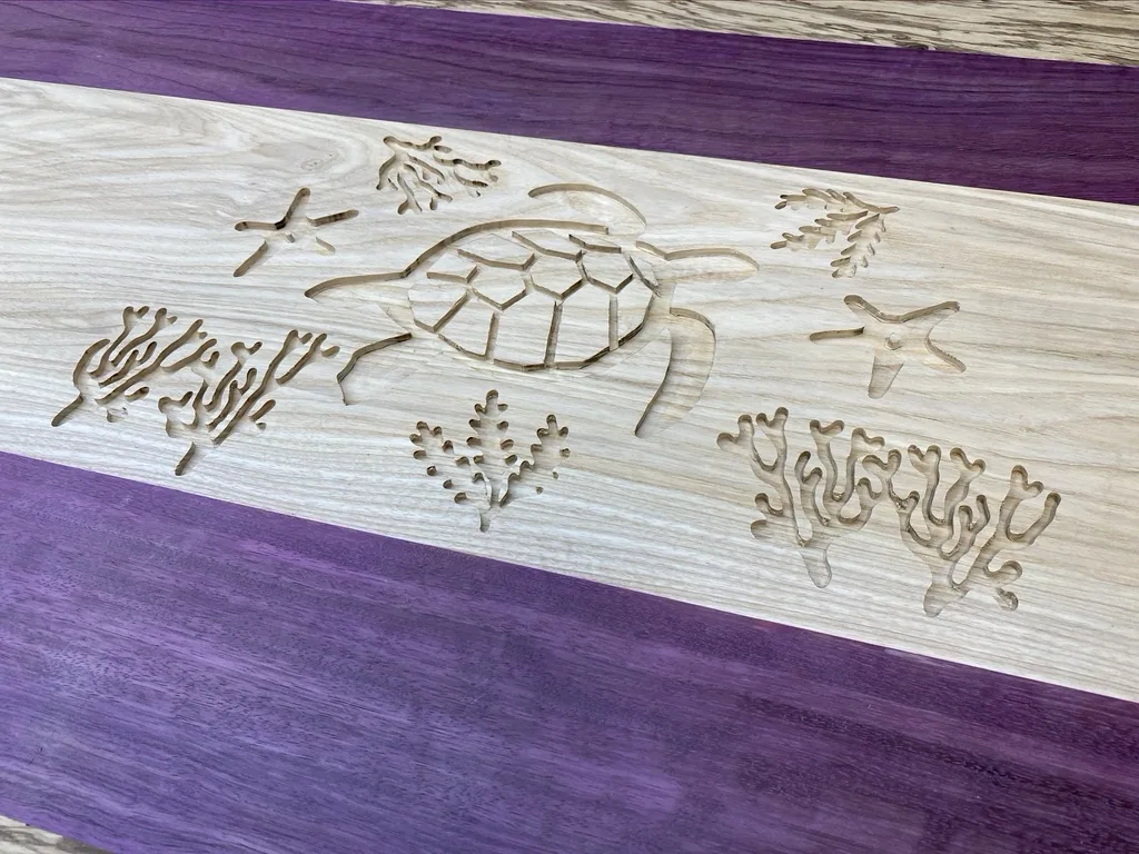 The turtle and seaweed design routed into the ash center