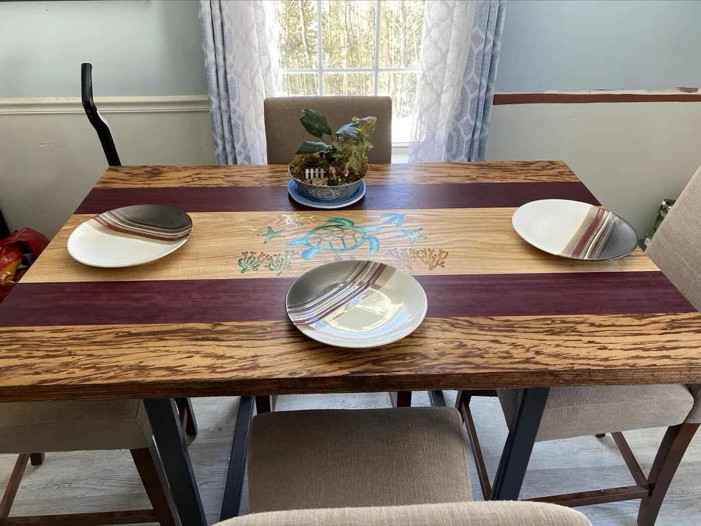 Finished turtle inlay dining table set with plates in a sunlit dining room